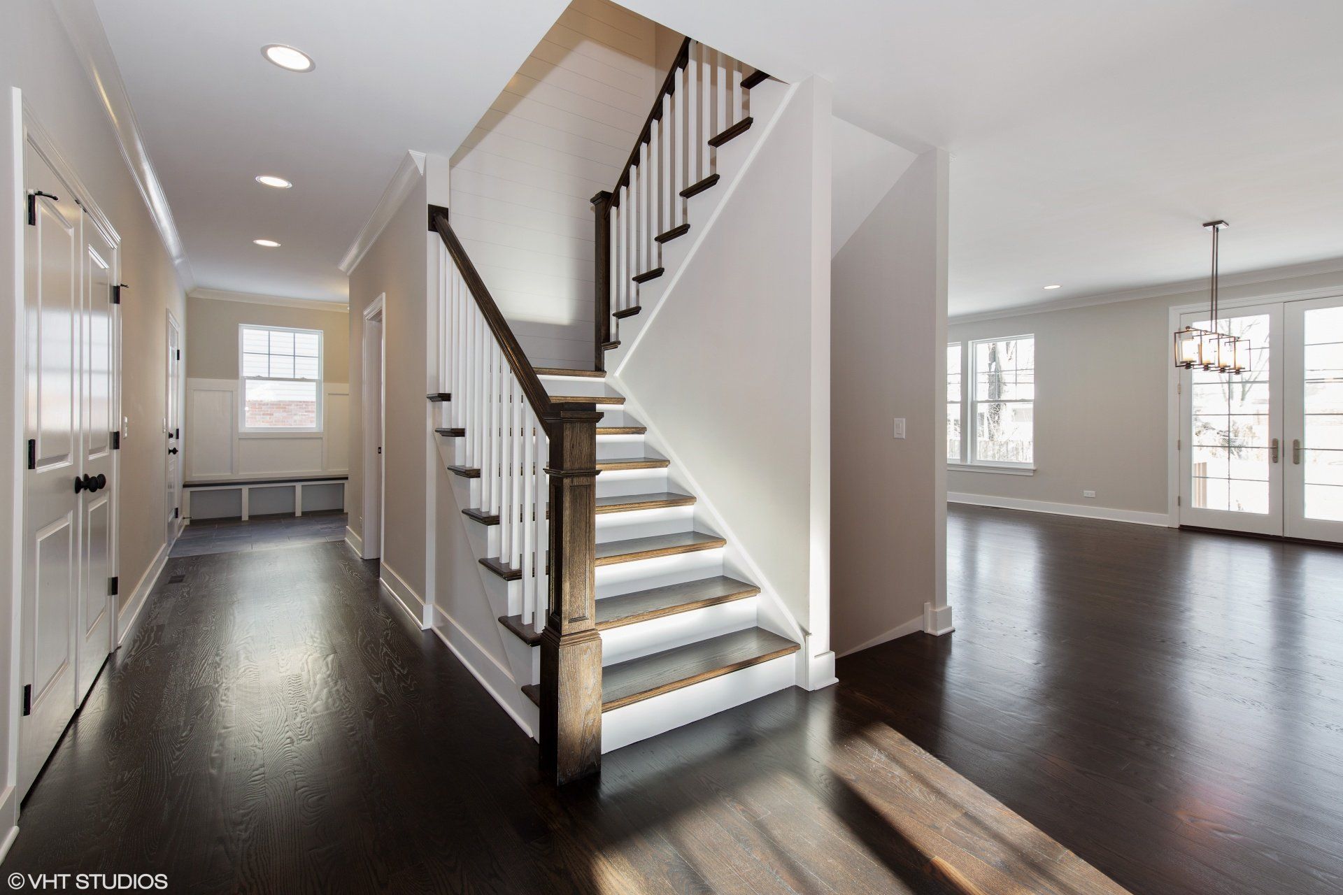 An empty hallway with a staircase in the middle of it