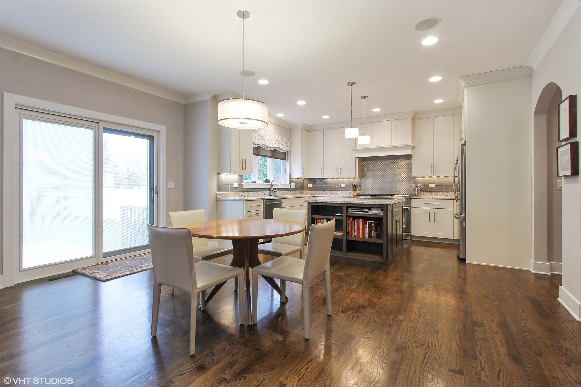 A kitchen with a table and chairs in it