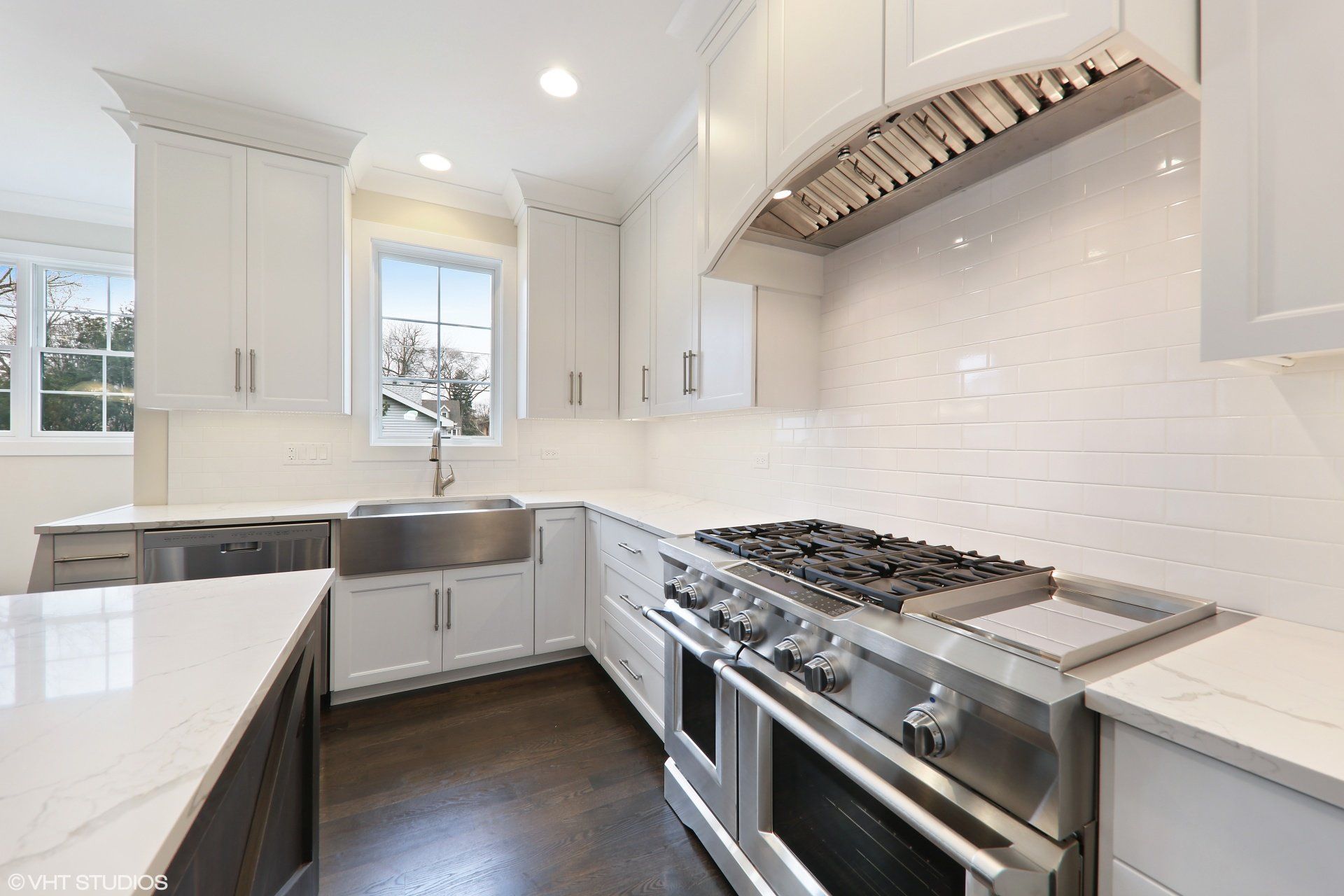 A kitchen with white cabinets and stainless steel appliances