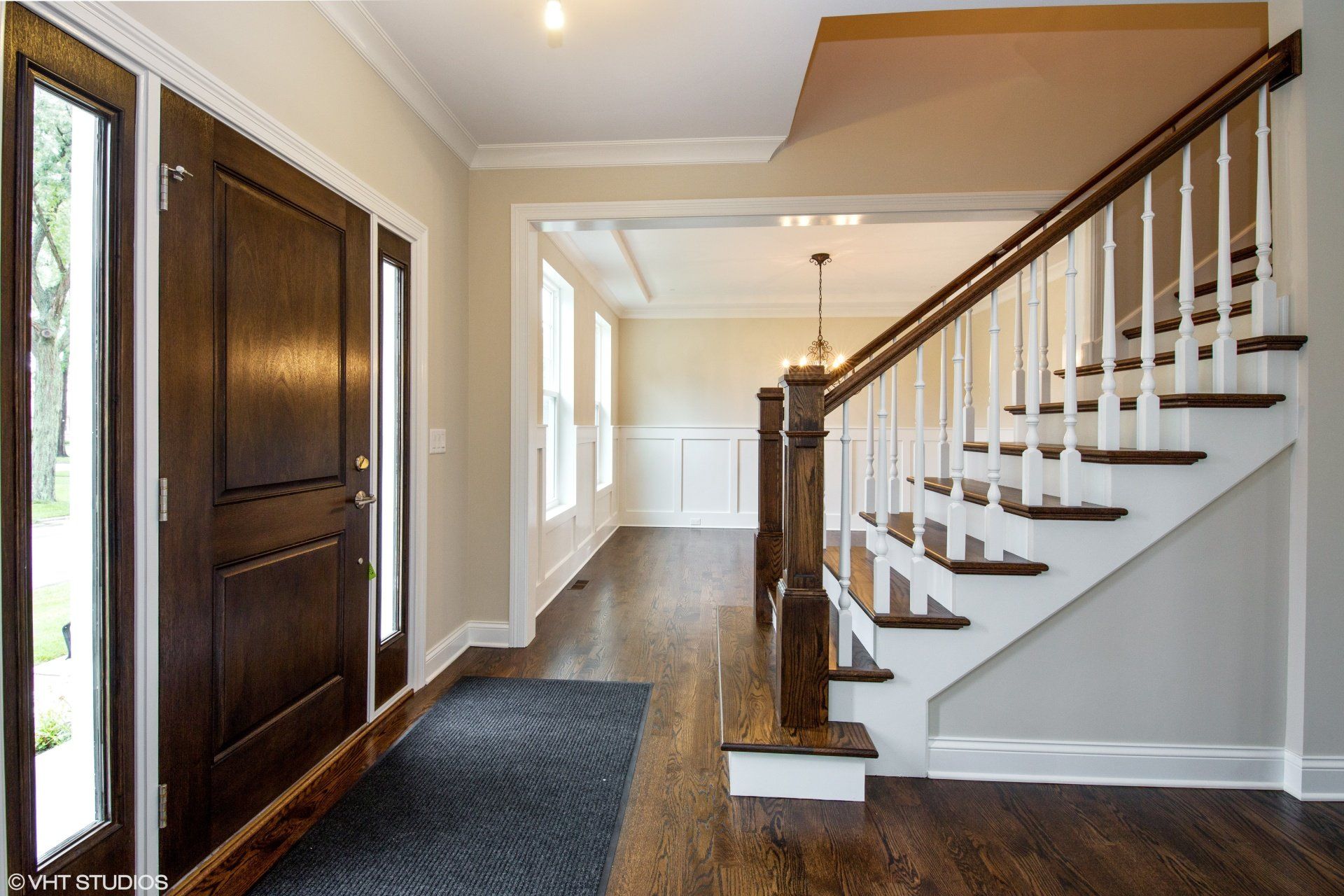 A hallway with stairs leading up to the second floor of a house.
