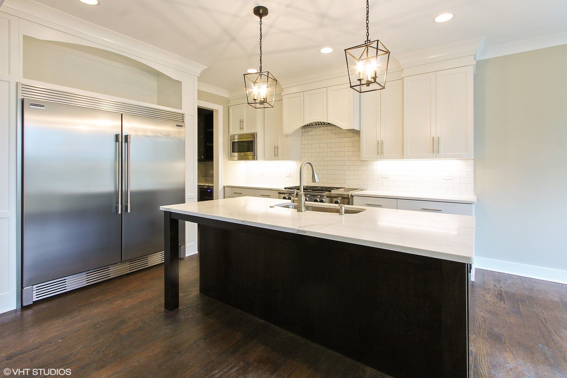 A kitchen with stainless steel appliances and white cabinets