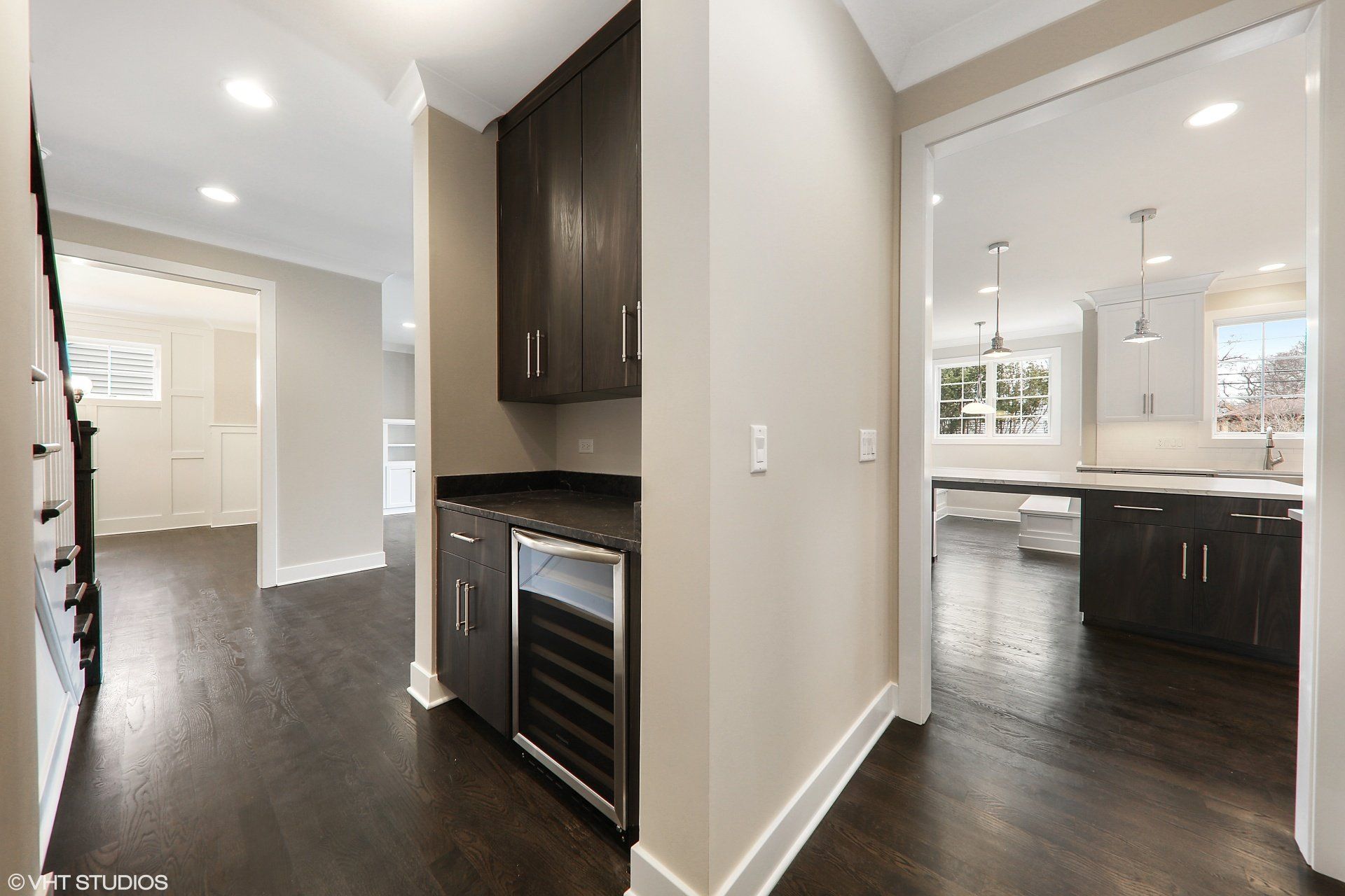A hallway in a house with a wine cooler in it