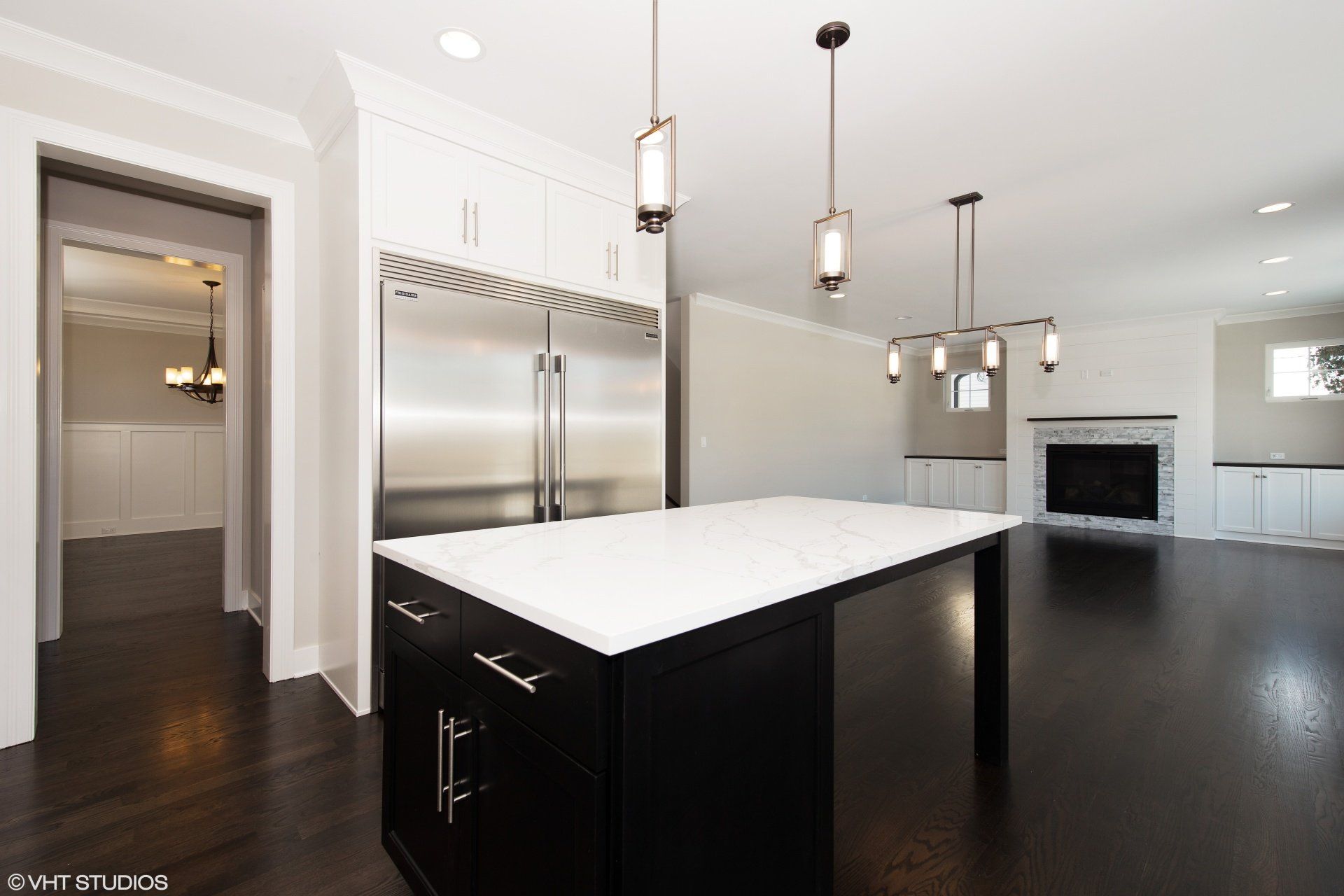 A kitchen with a large island and stainless steel appliances