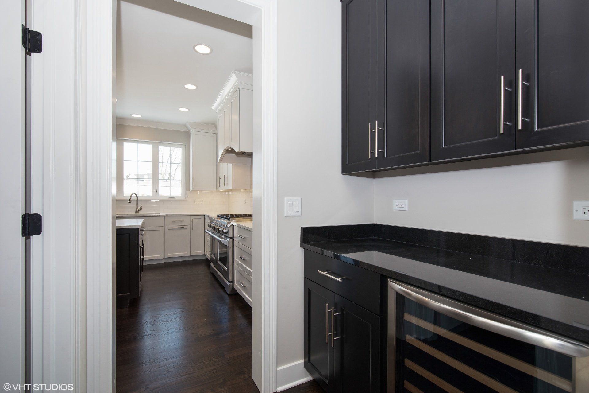 A kitchen with black cabinets and stainless steel appliances.