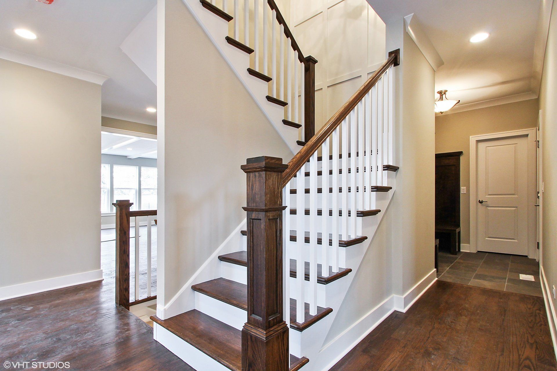 A staircase with white railings and wooden steps in a hallway