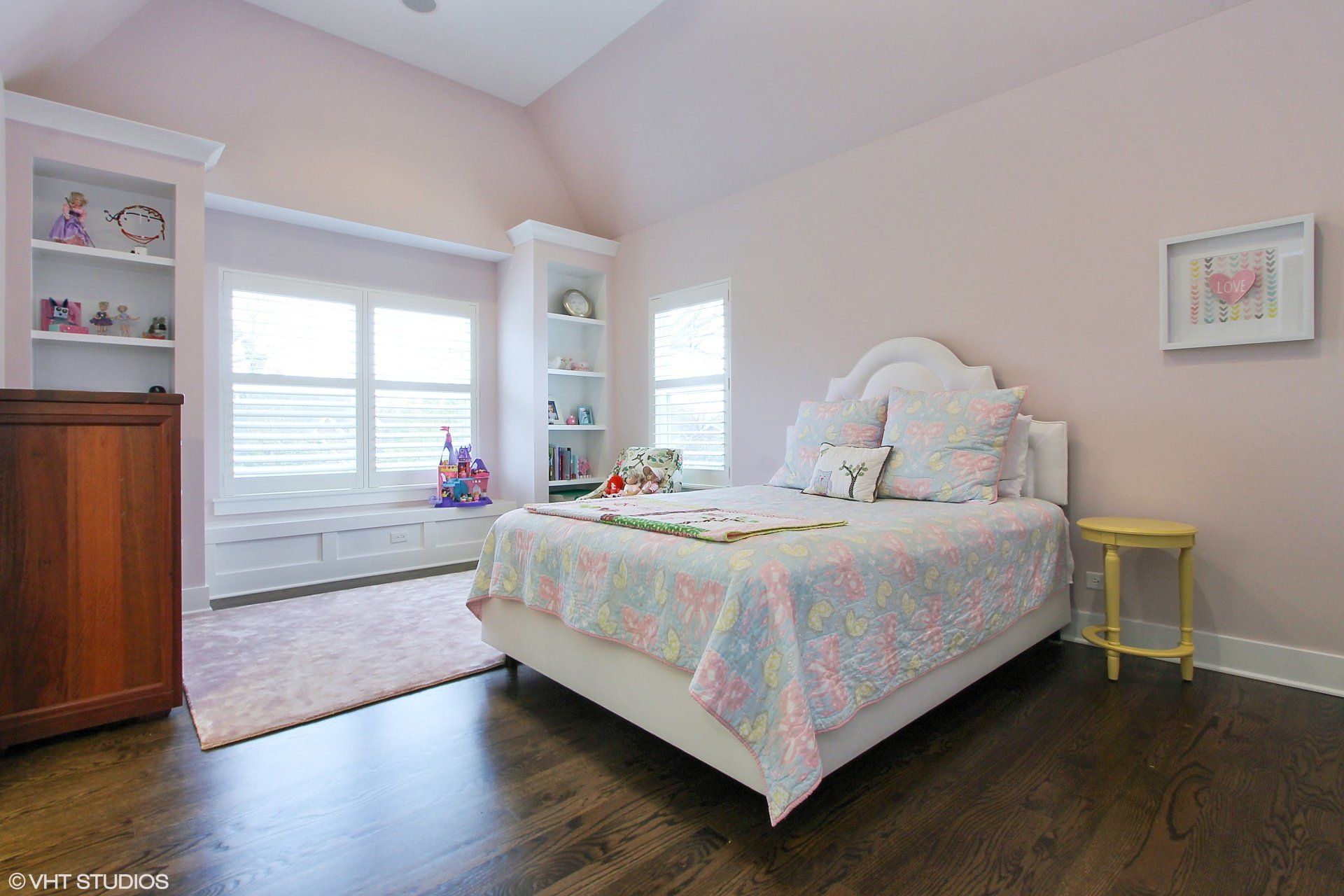 A bedroom with a bed , dresser , shelves and a window.