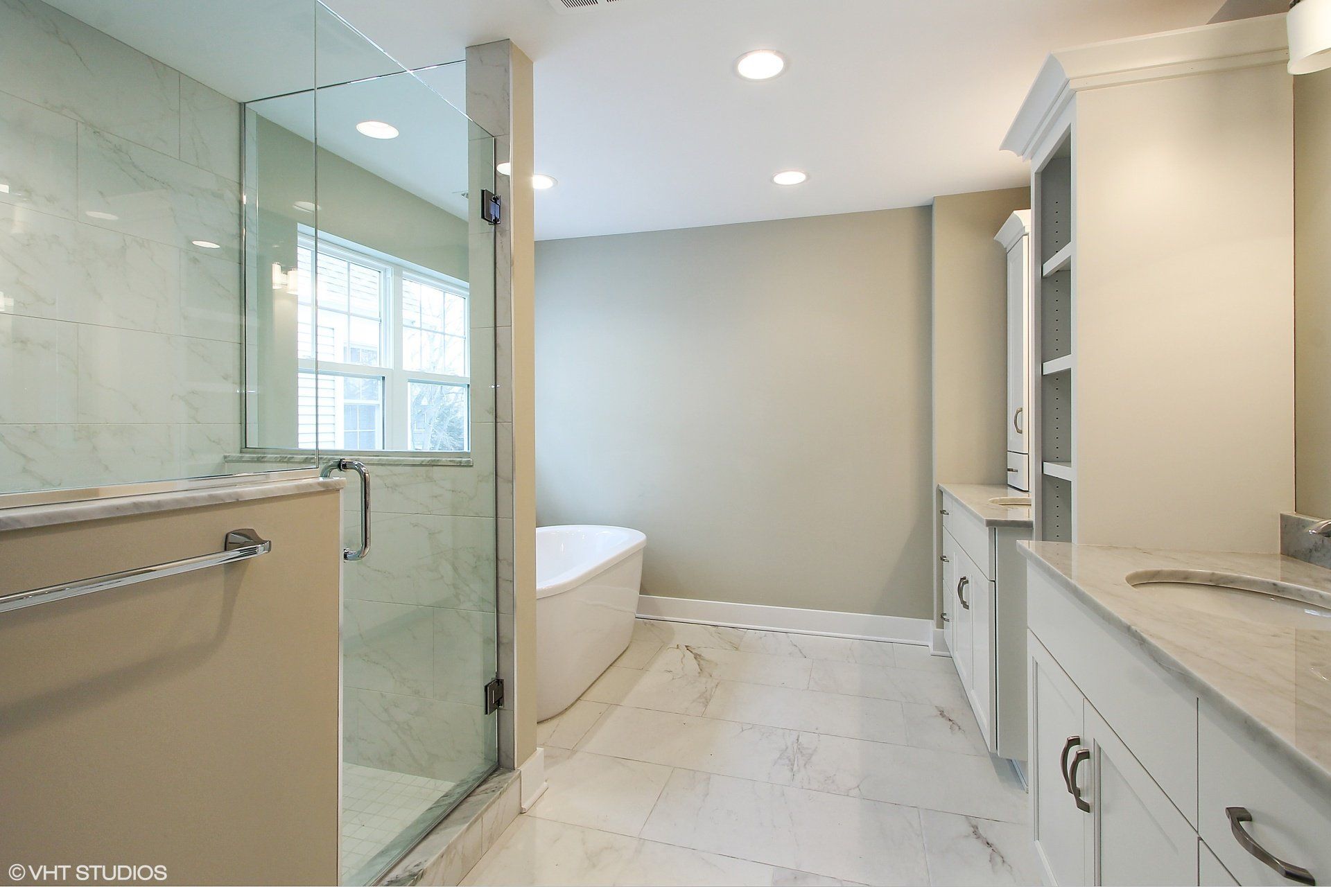 A bathroom with a bathtub and a walk in shower.