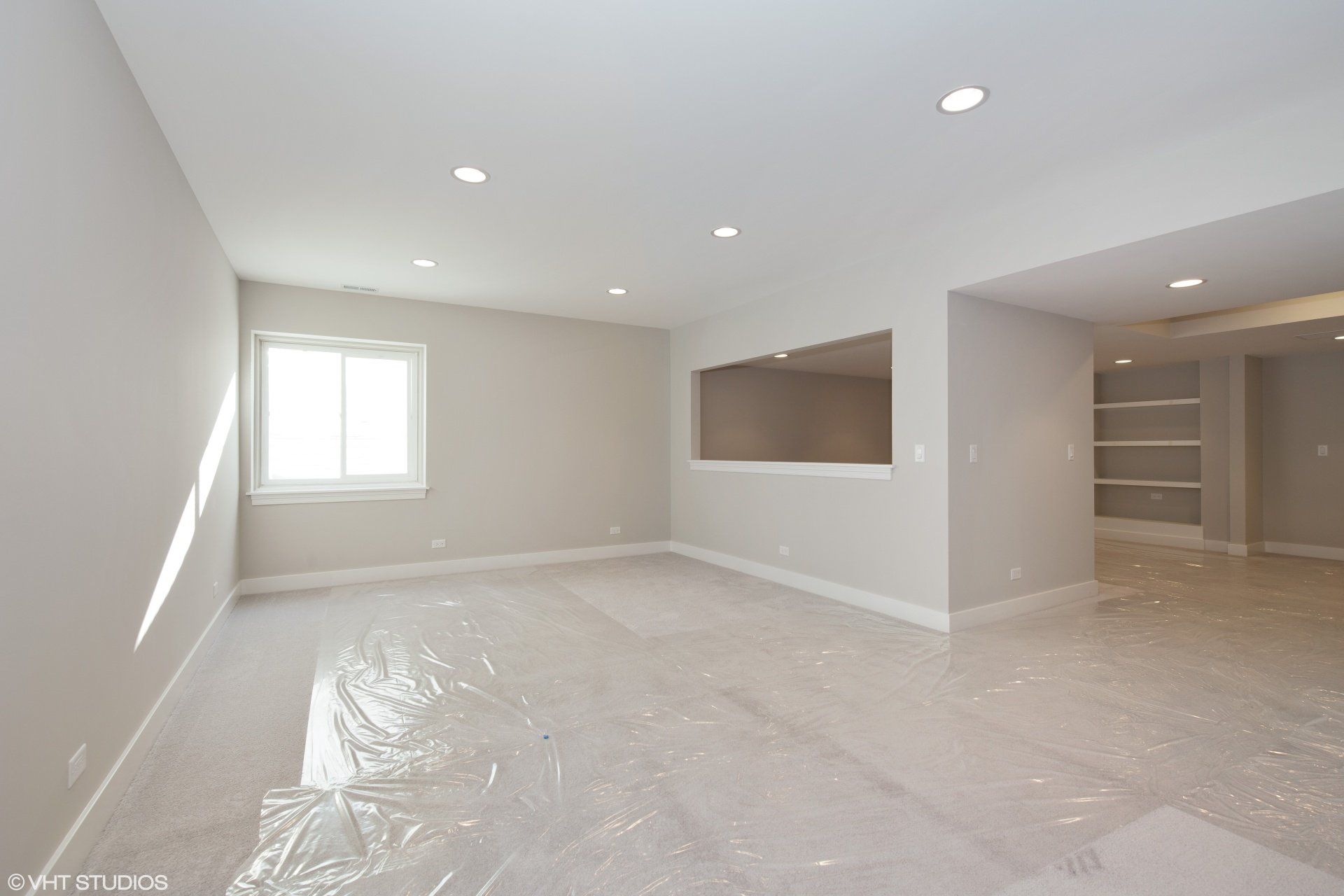 An empty room with white walls and a window