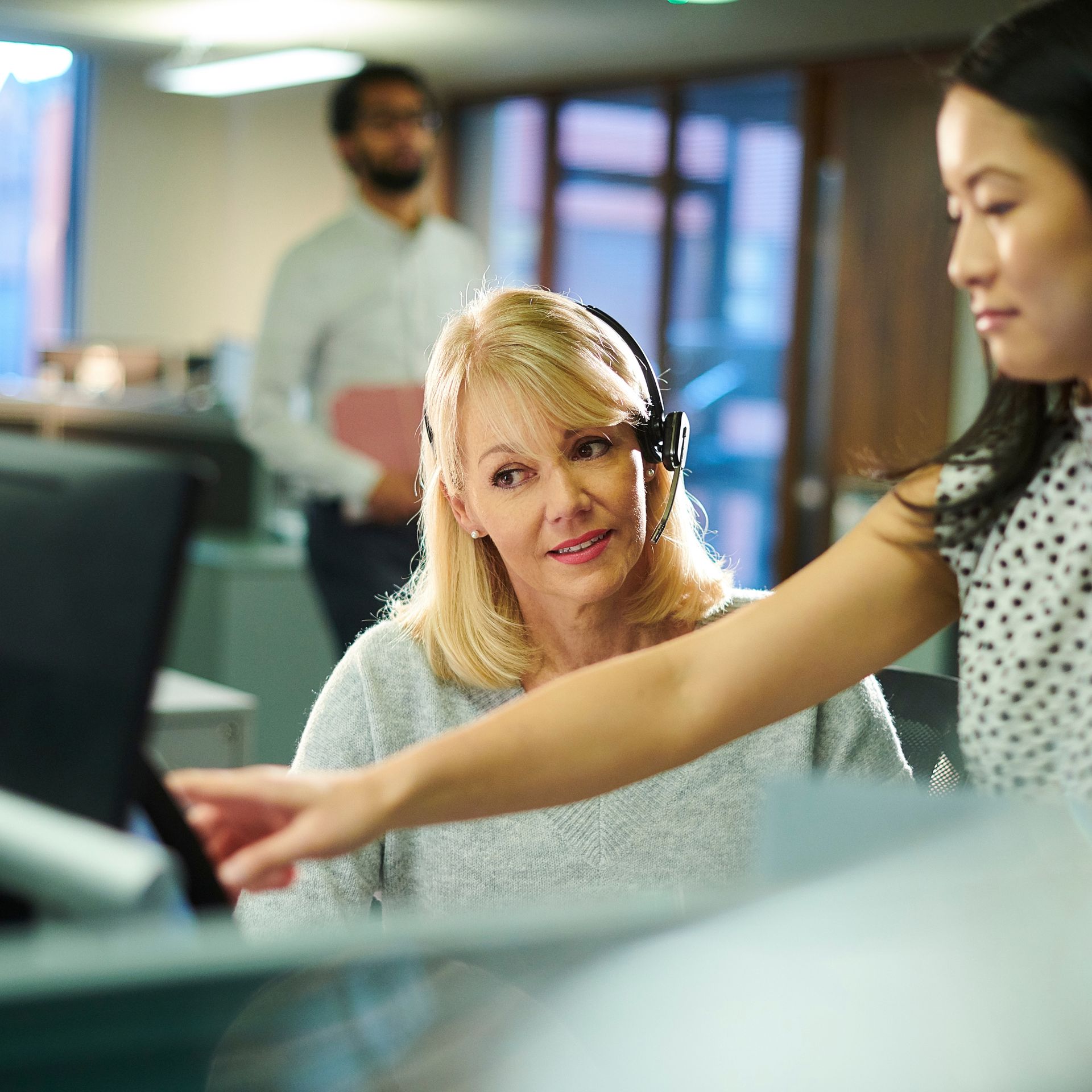 Coworker helping or coaching another coworker