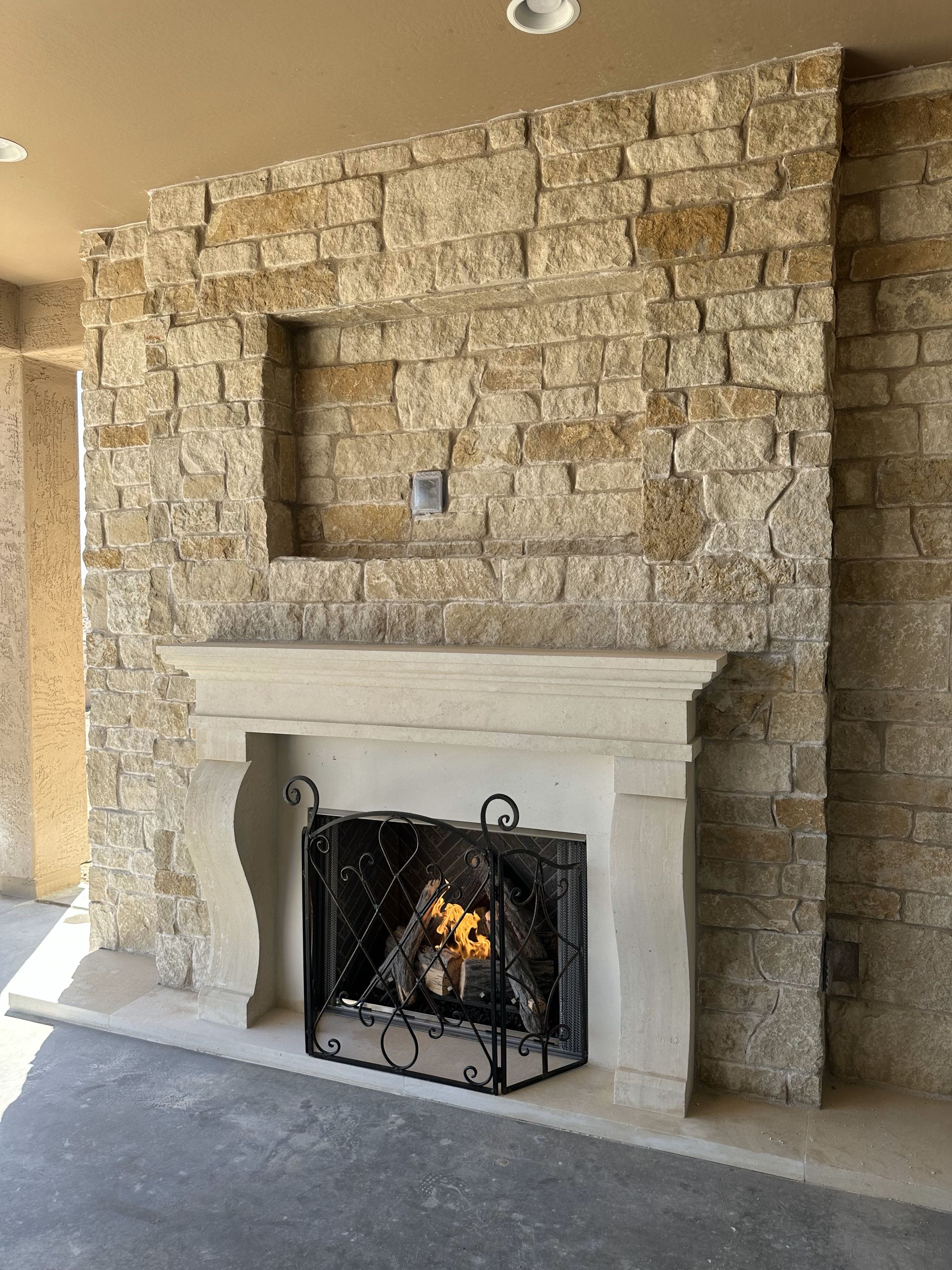 A fireplace in a living room with a brick wall behind it.