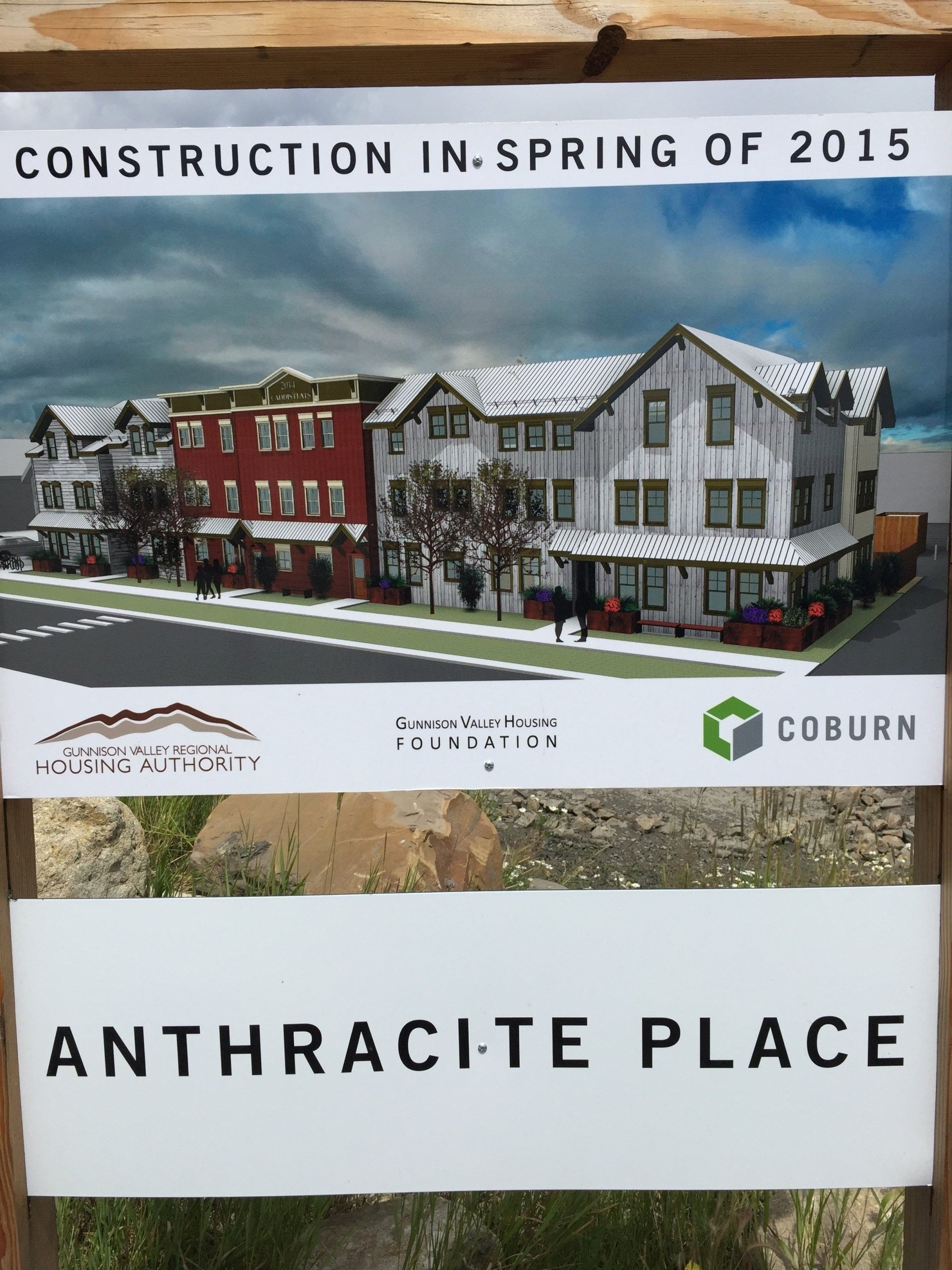 Sign for Anthracite Place construction, with building rendering, stating construction in spring 2015.