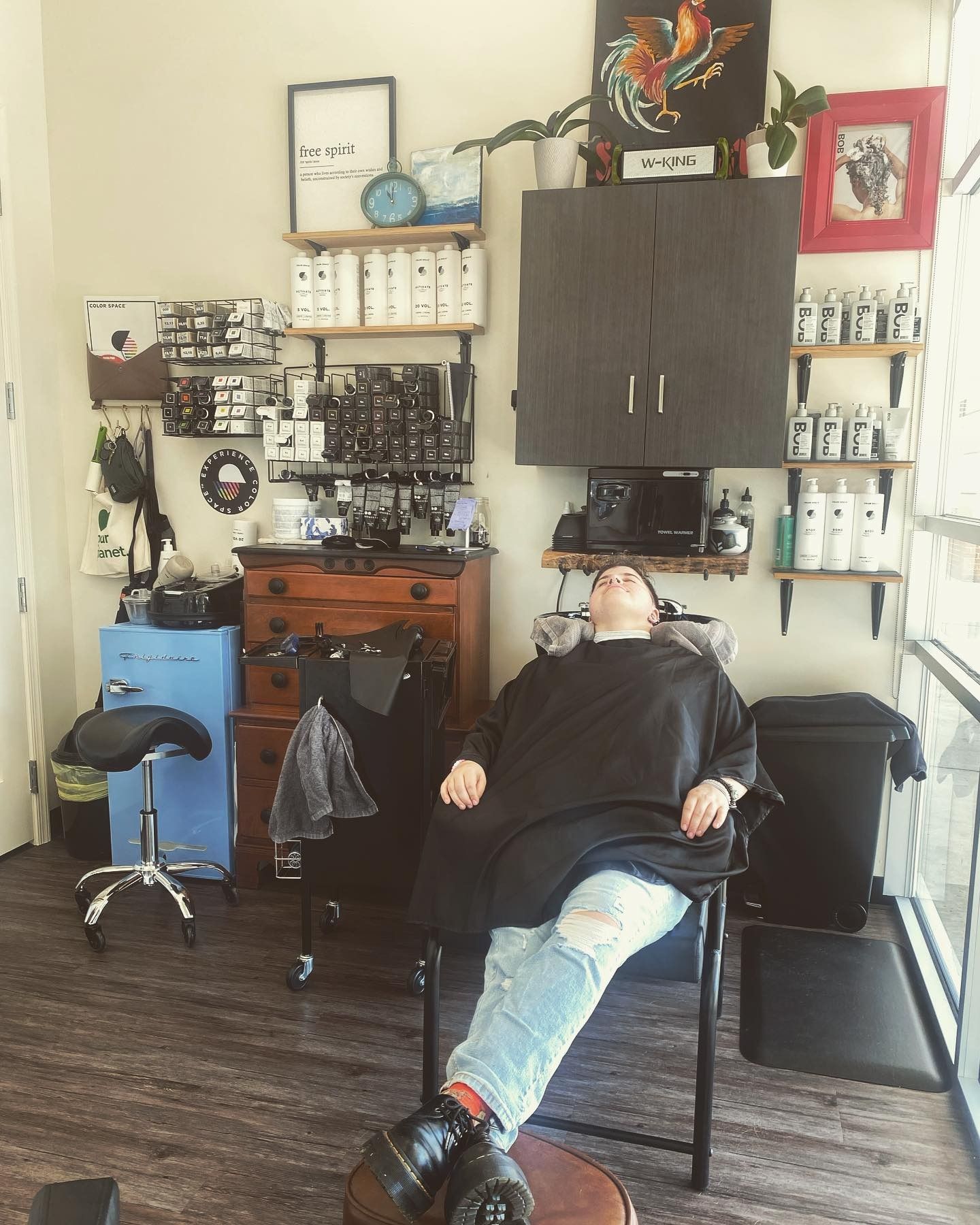 A woman is laying in a chair in a salon.