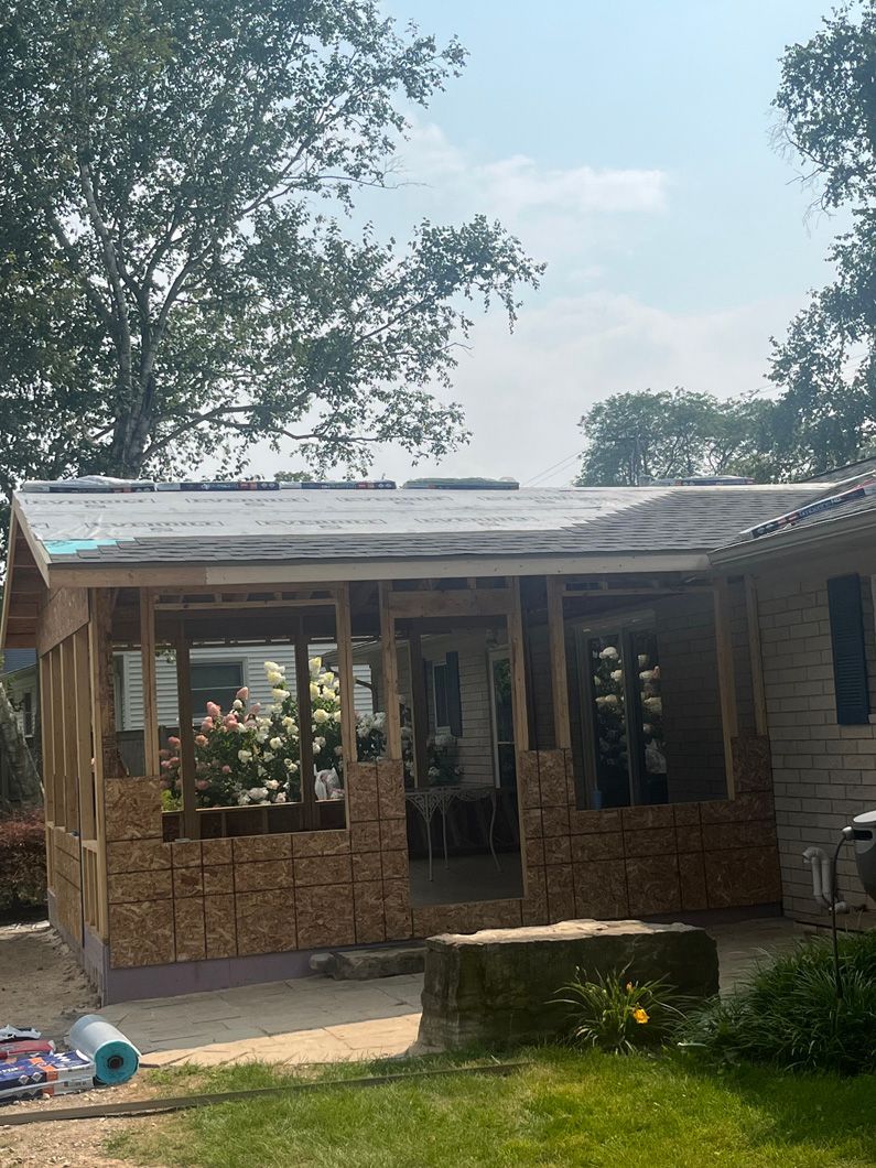 Cabin under construction with partially completed brickwork and roof.