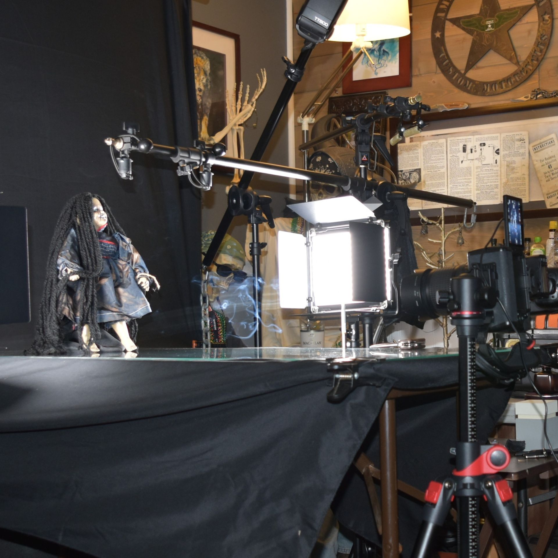 Woman in a blue and white checkered blazer smiles at the camera against a white backdrop.