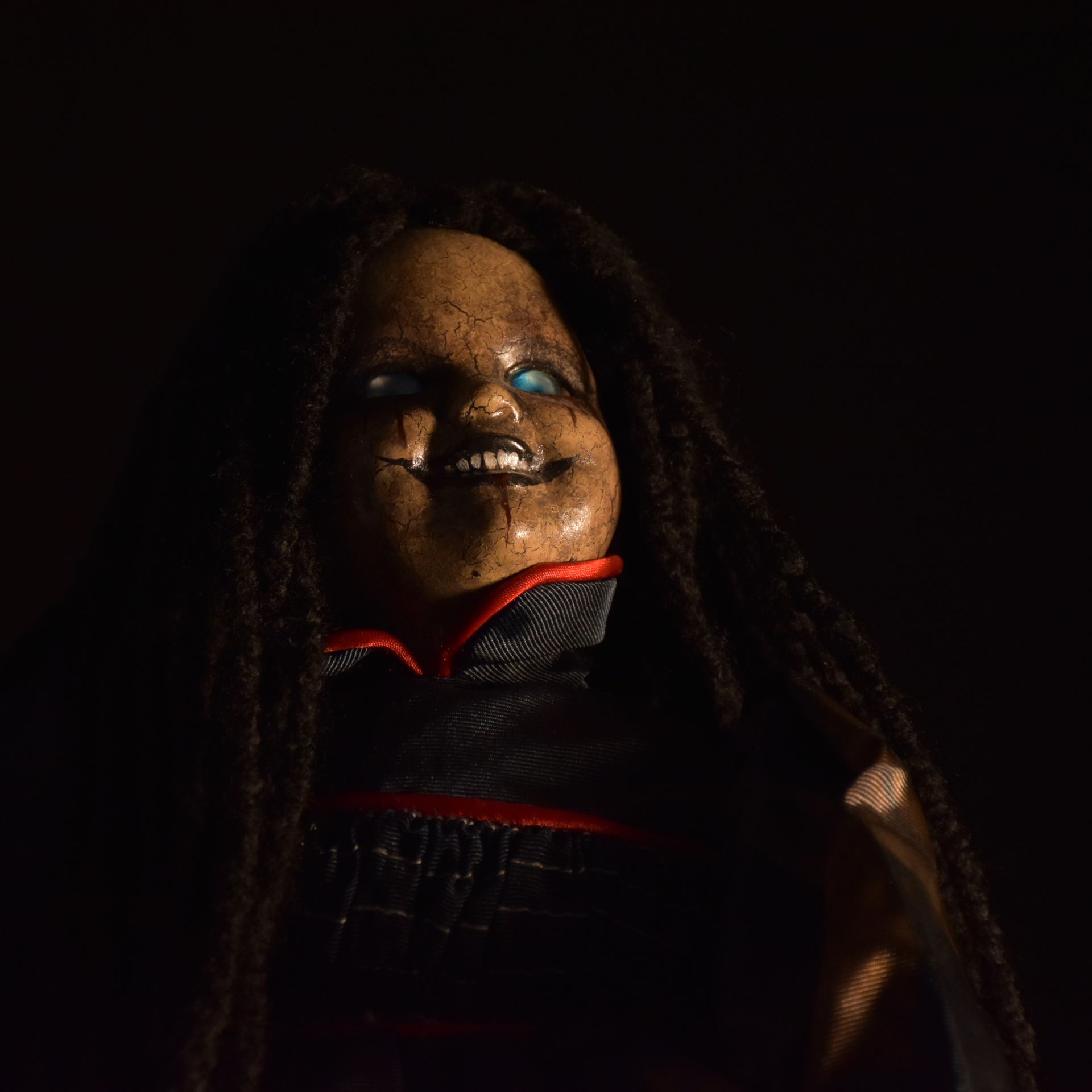 Person holding camera, arranging makeup products on a white surface, indoors.