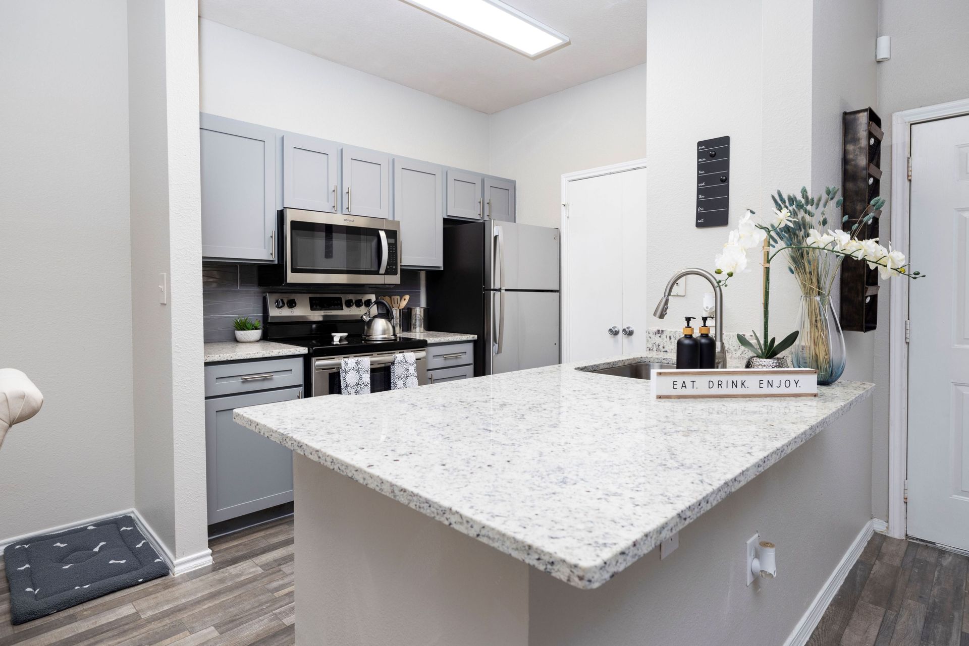 A kitchen with a granite counter top and stainless steel appliances at Allure at Shavano.