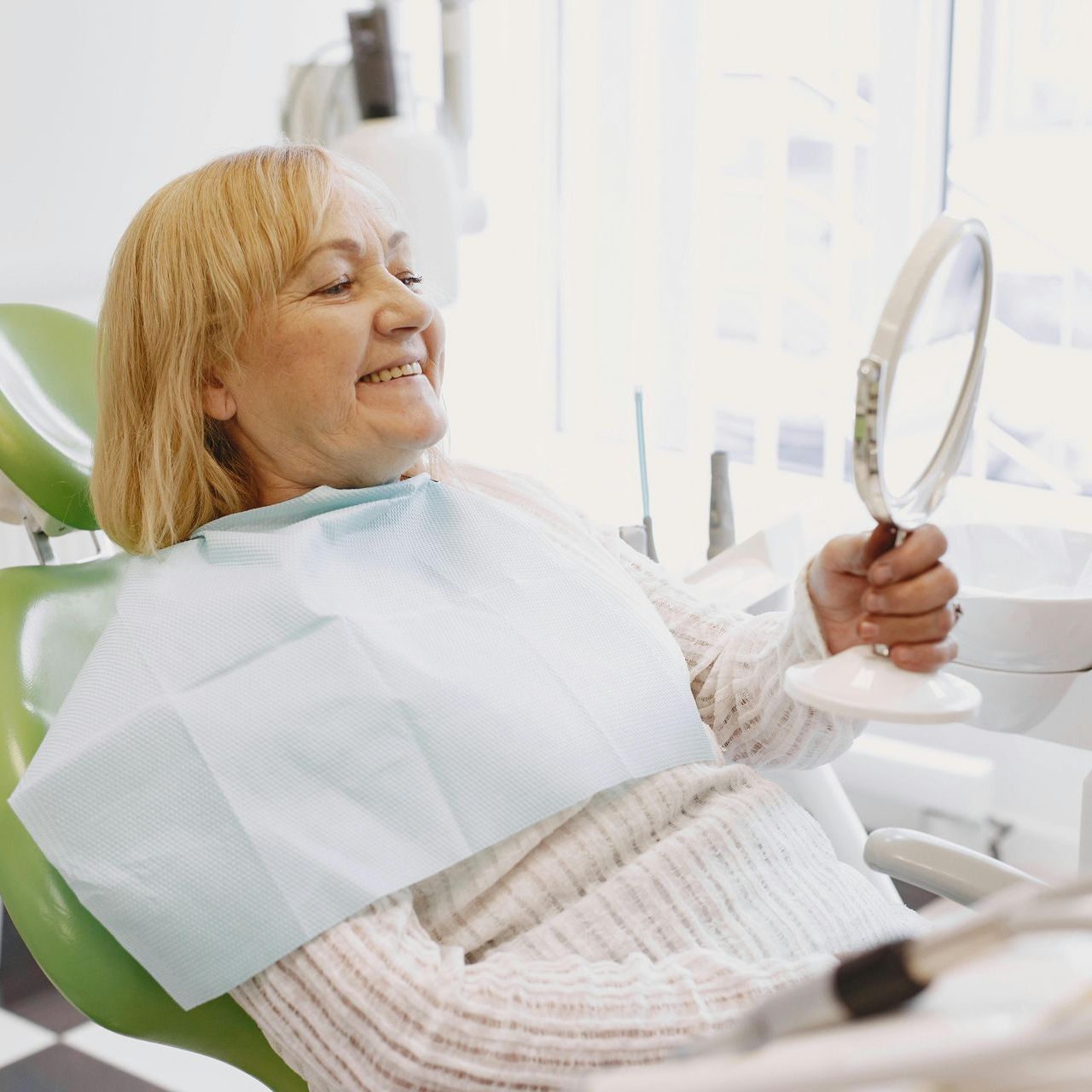 woman smiling in front of small mirror