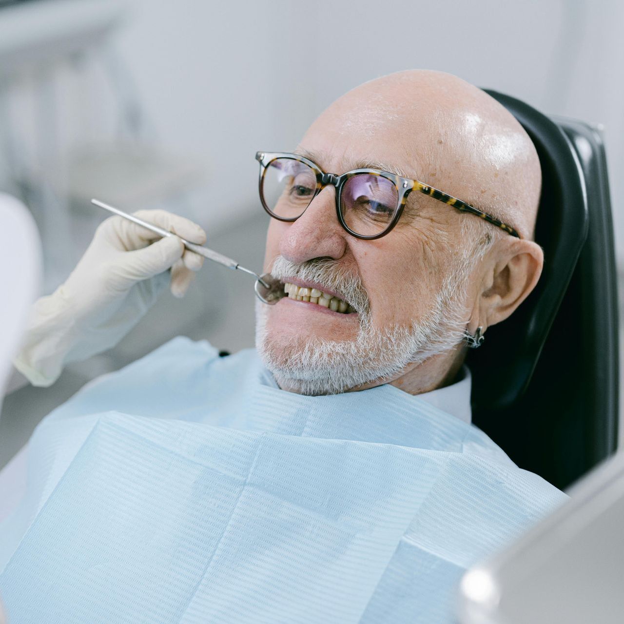 A man is getting his teeth examined by a dentist.