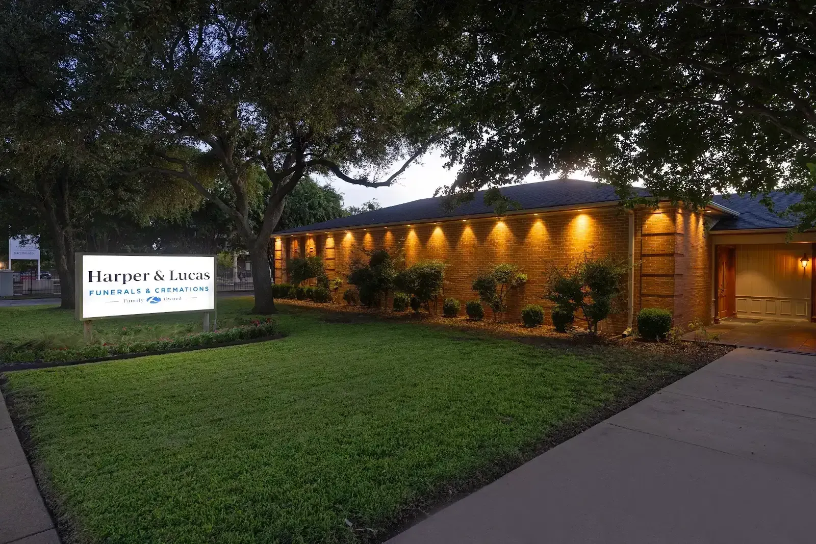 A sign for williams and lucas funeral home is in front of a building.