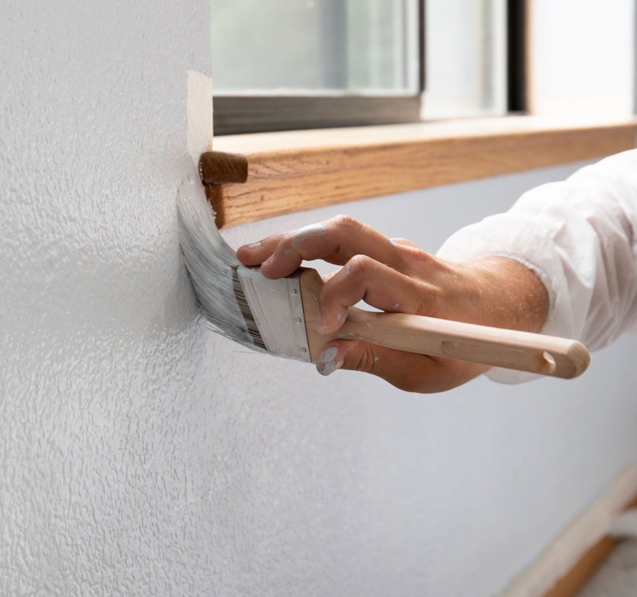 White Painting Near Window — Los Osos, CA — Pacific Coast Painting and Design Inc