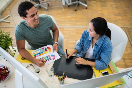 two workers sitting inside the office