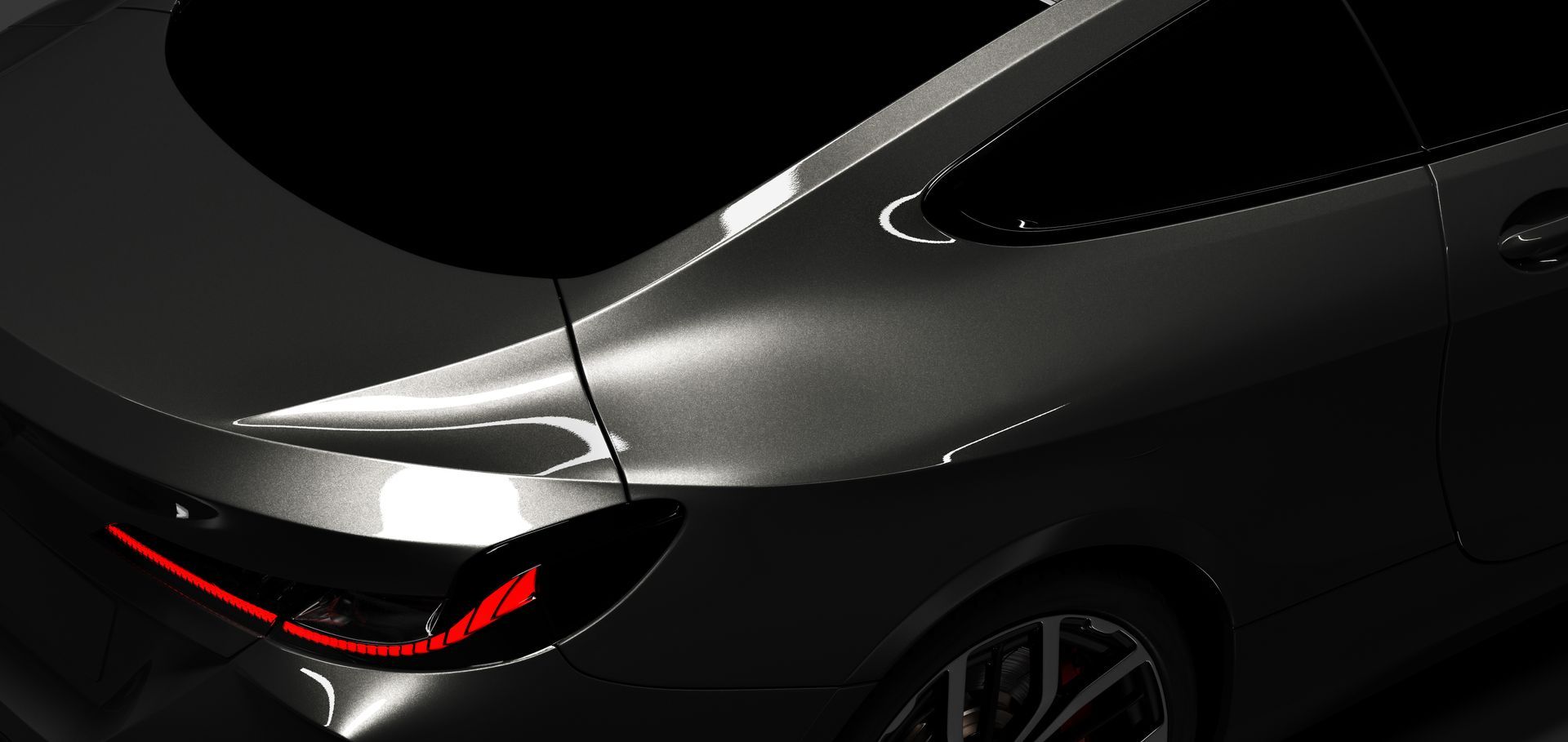 Close-up of a sleek black car’s rear quarter and taillight on a dark background