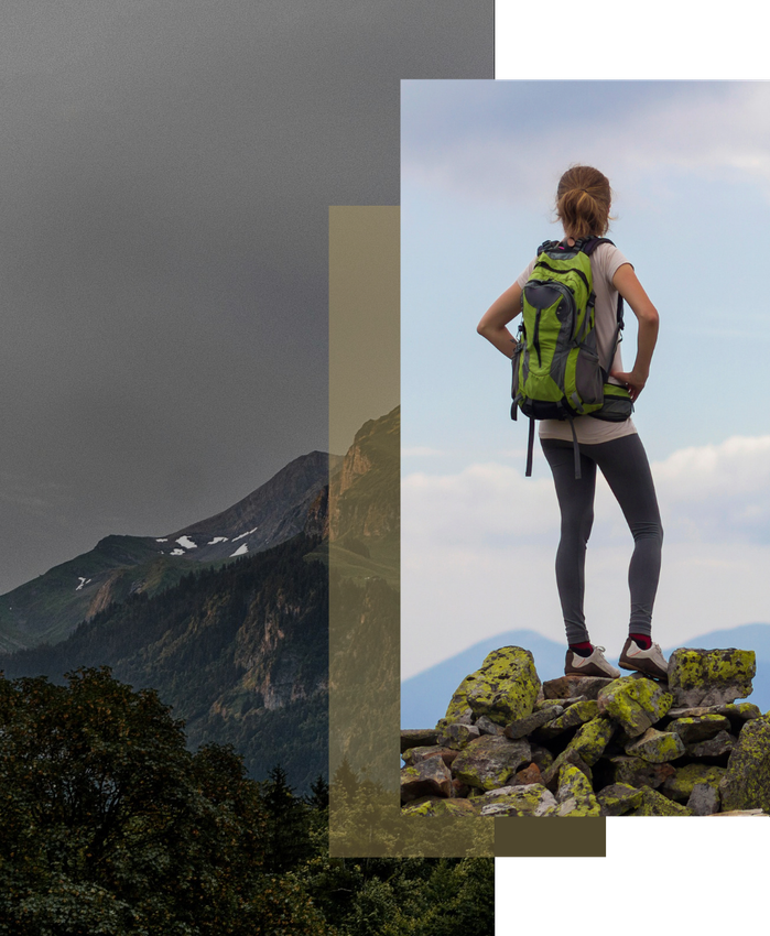 Lisa Renshaw stands proudly on the top of mountain she hiked over looking the valley.