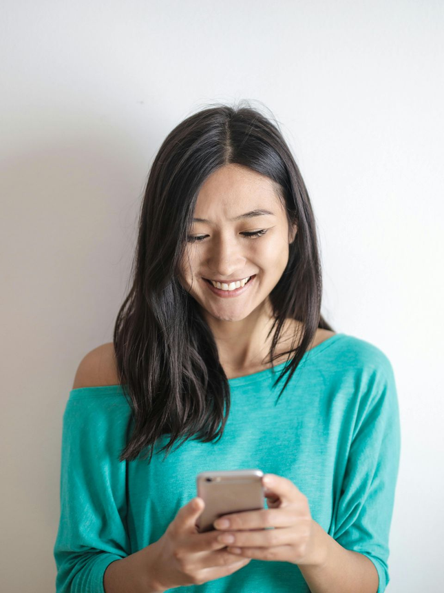 Lisa Renshaw stands proudly on the top of mountain she hiked over looking the valley.