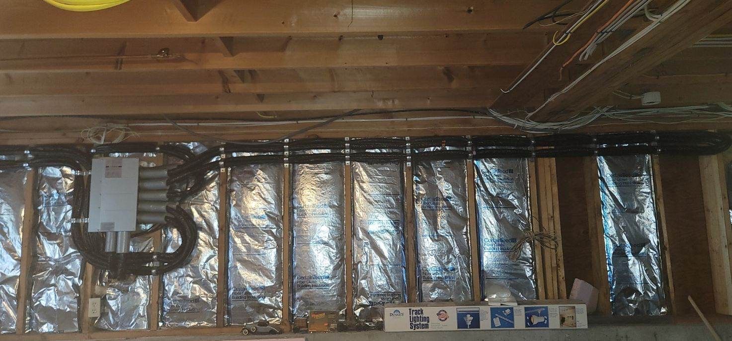 Wooden framing with insulation and electrical components.