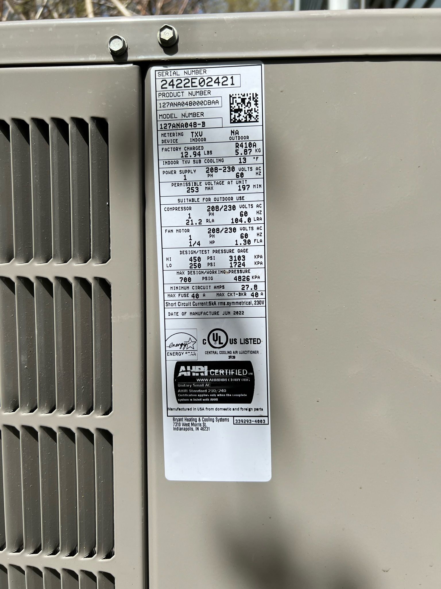 A white label with black text on an air conditioning unit.