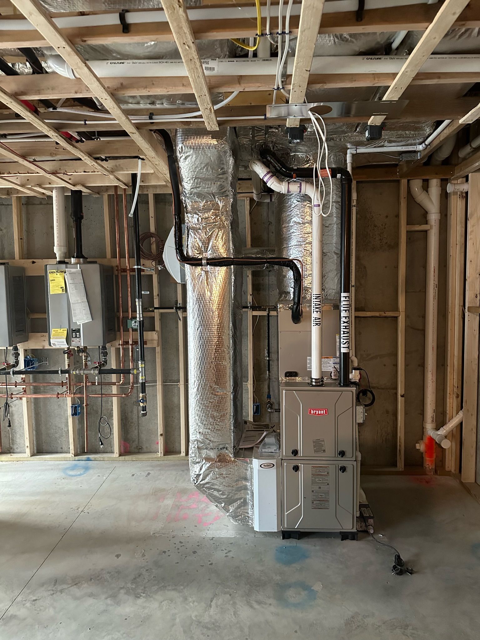Interior view of unfinished construction with HVAC system and ductwork installed.
