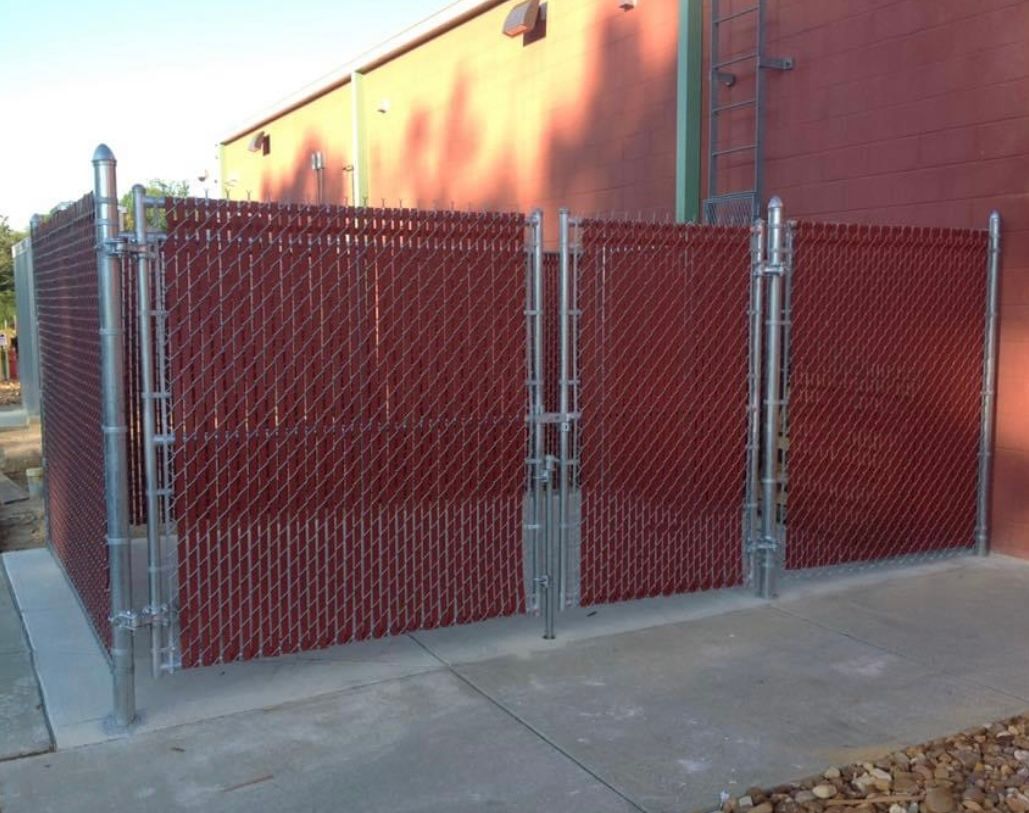 Chain link fence with privacy slats
