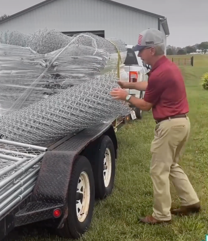 George Bowles ready to install chain link fence.