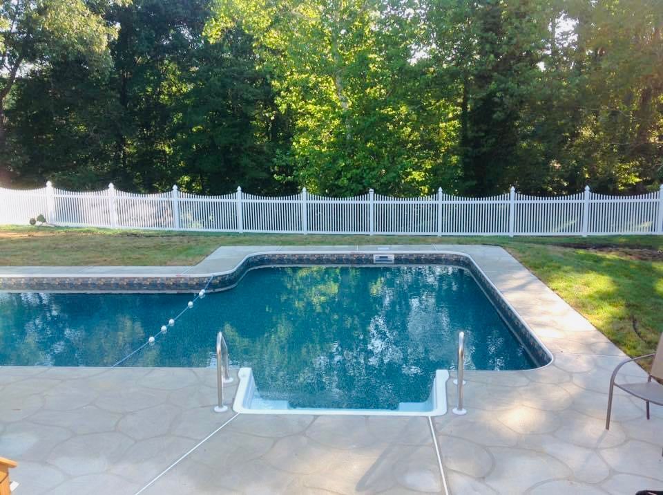 vinyl scallop fence around a pool