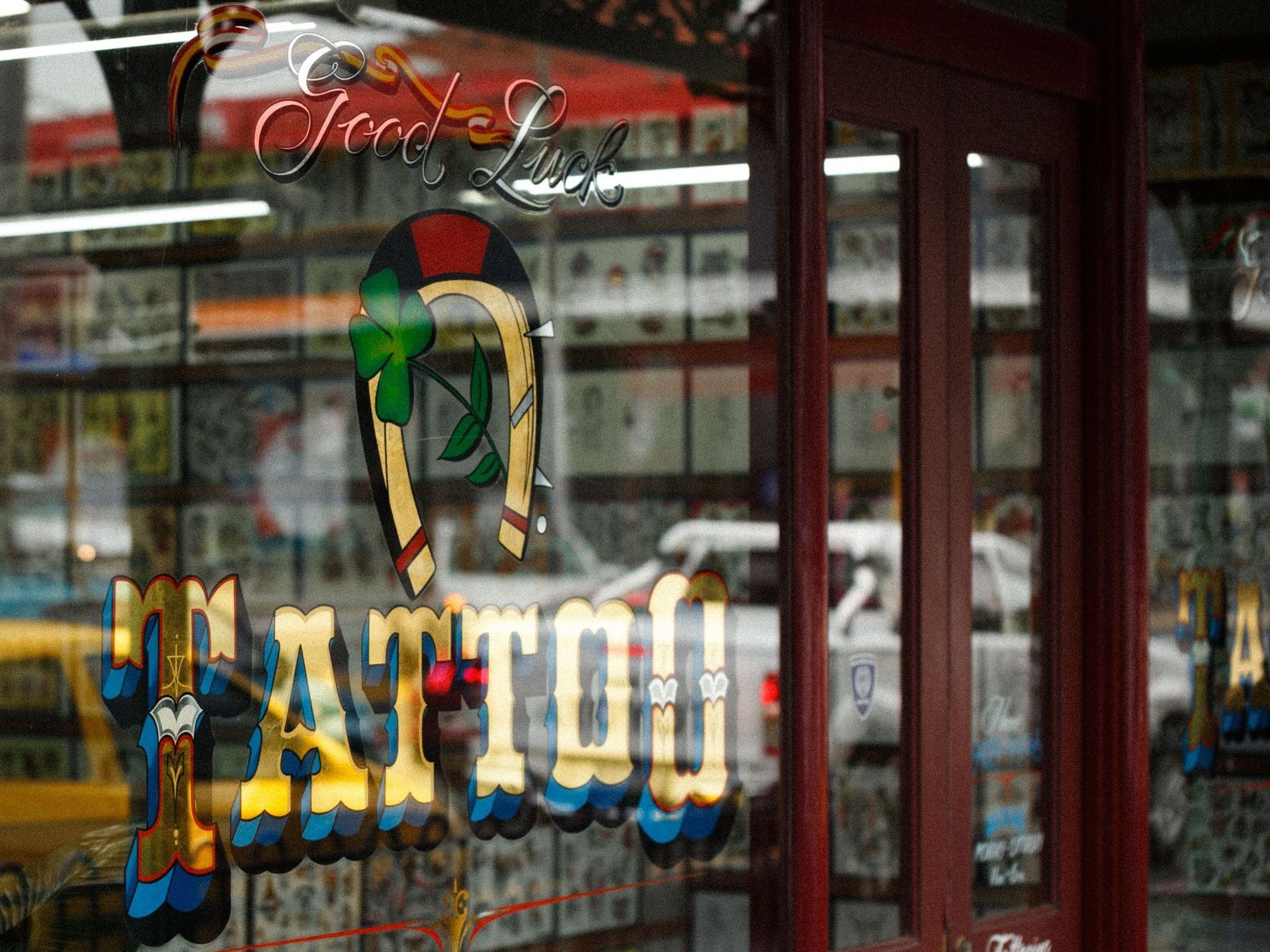 a tattoo shop has a sign that says good luck tattoo
