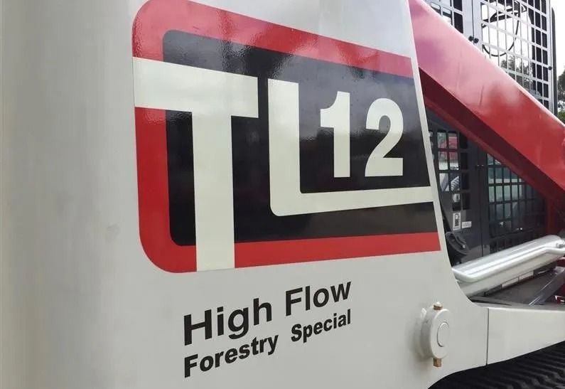 White and Red Tl12 Skid Steer Loader Logo — Ace Clearing & Mulching In Old Bar, NSW