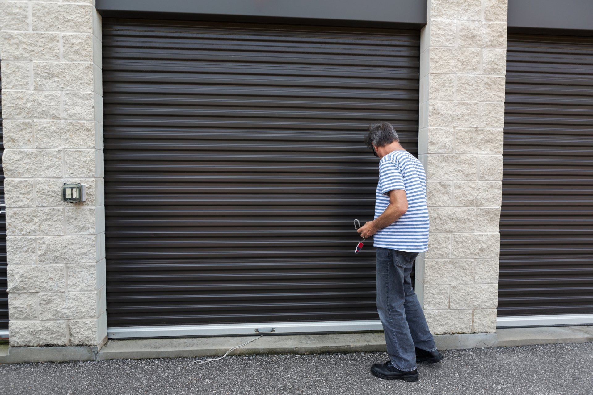Man Unlocking Self Storage Unit - Leighton Ave, AL - Quintard Self Storage