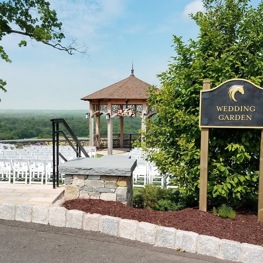 A sign that says wedding garden is next to a gazebo