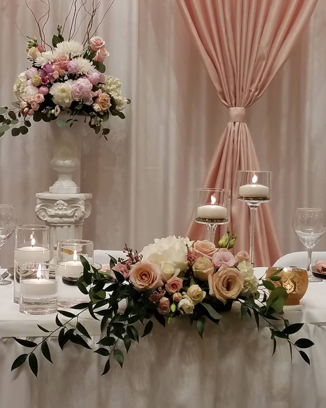 A table with flowers and candles on it
