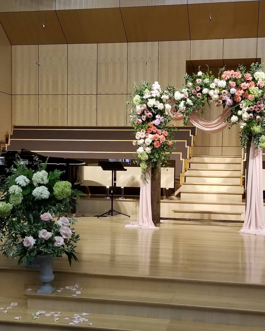 A stage with flowers on it and stairs in the background