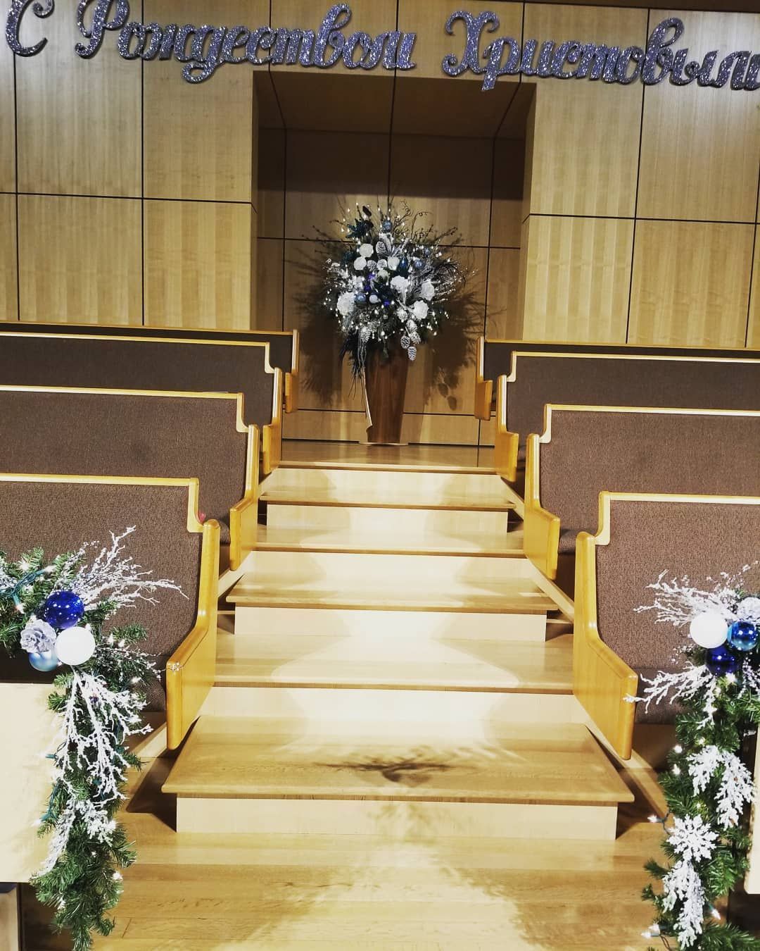 A church is decorated for christmas with flowers and snowflakes
