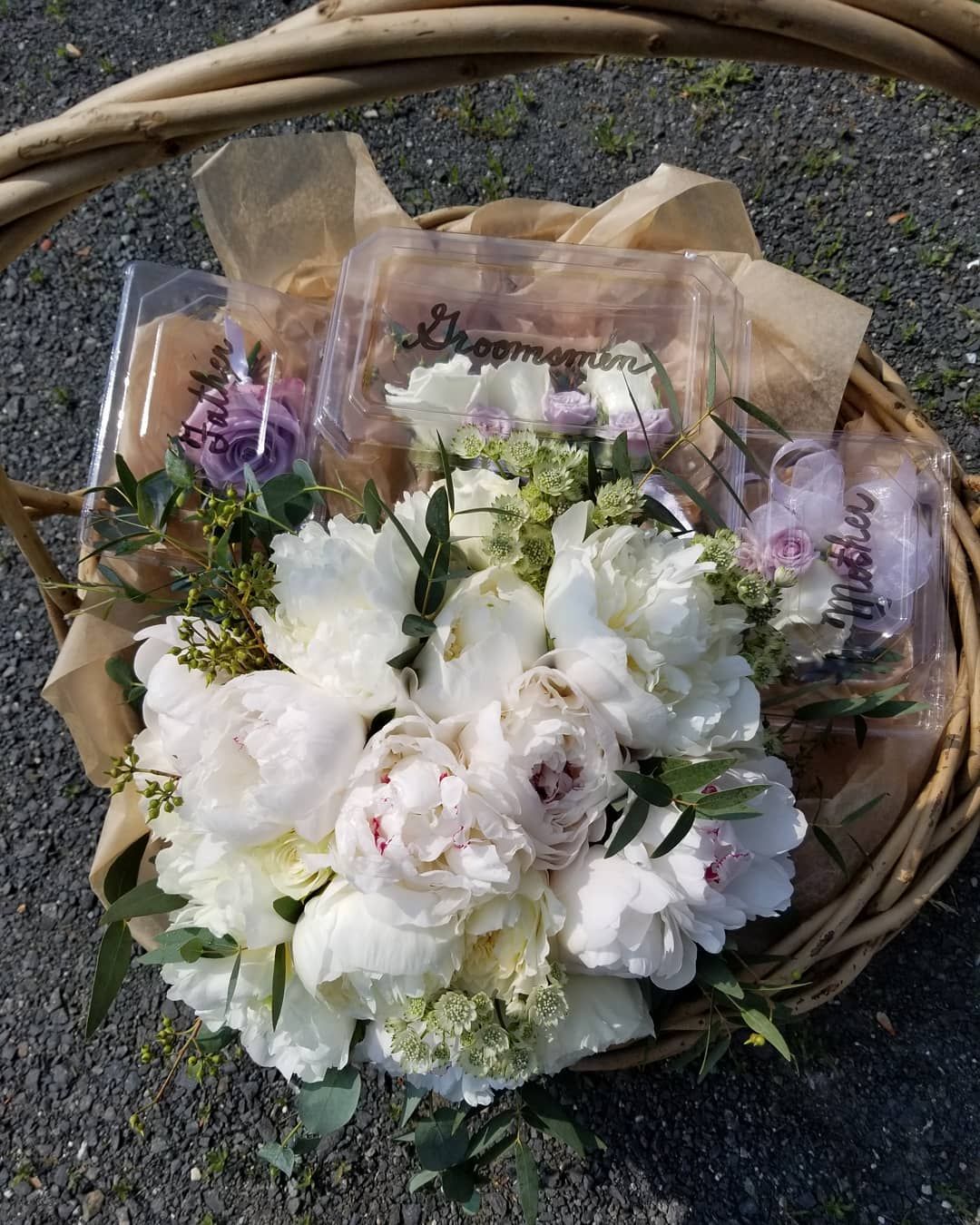 A wicker basket filled with white and pink flowers
