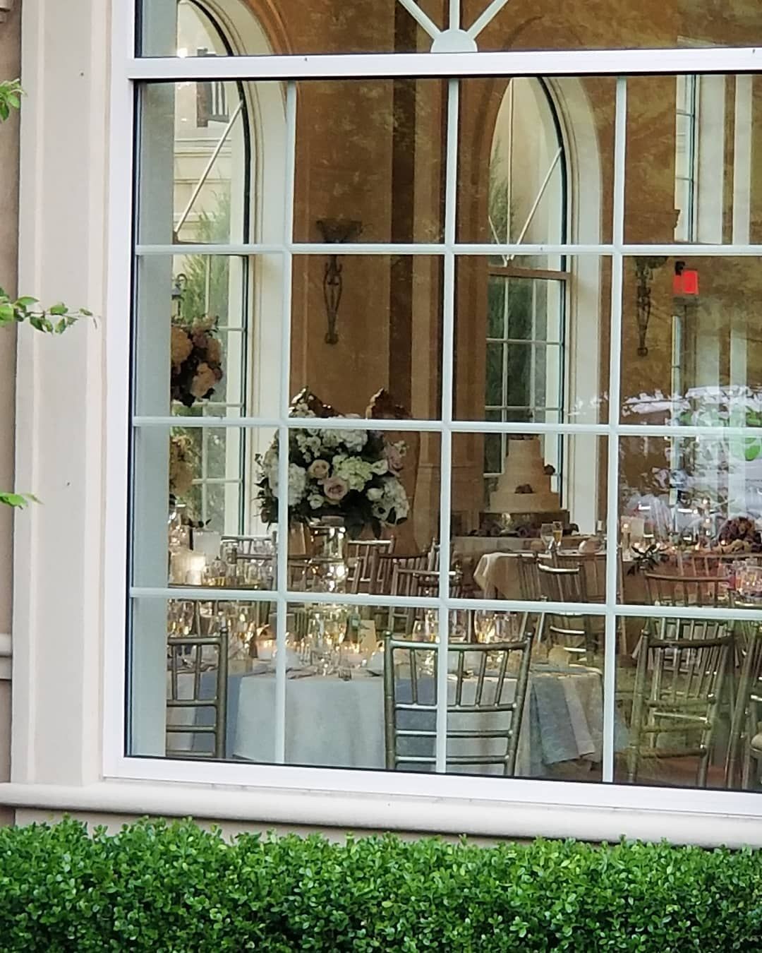 The inside of a building is reflected in the window