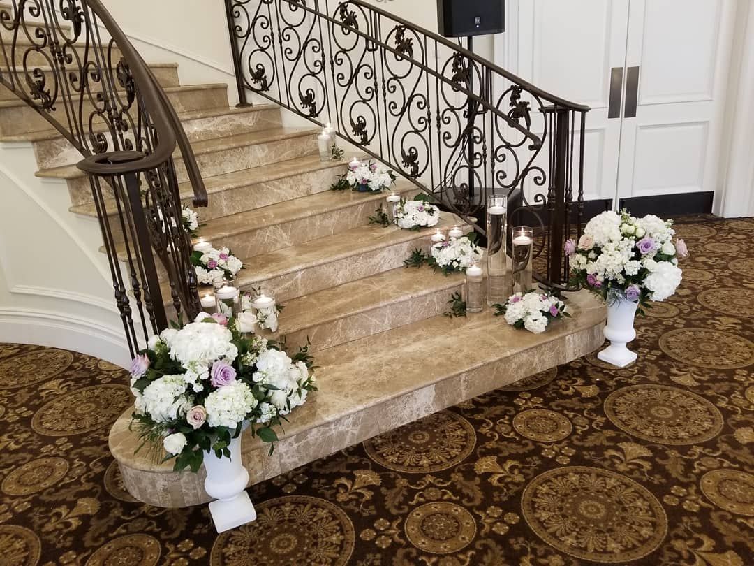 A set of stairs decorated with flowers and candles.