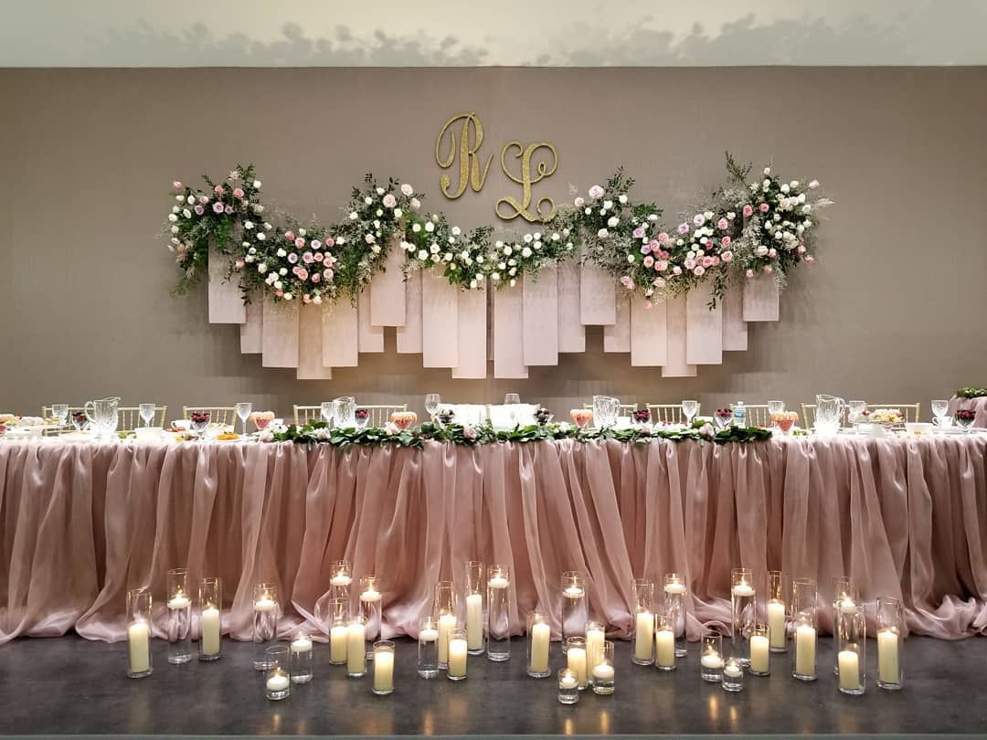A long table with candles and flowers on it.
