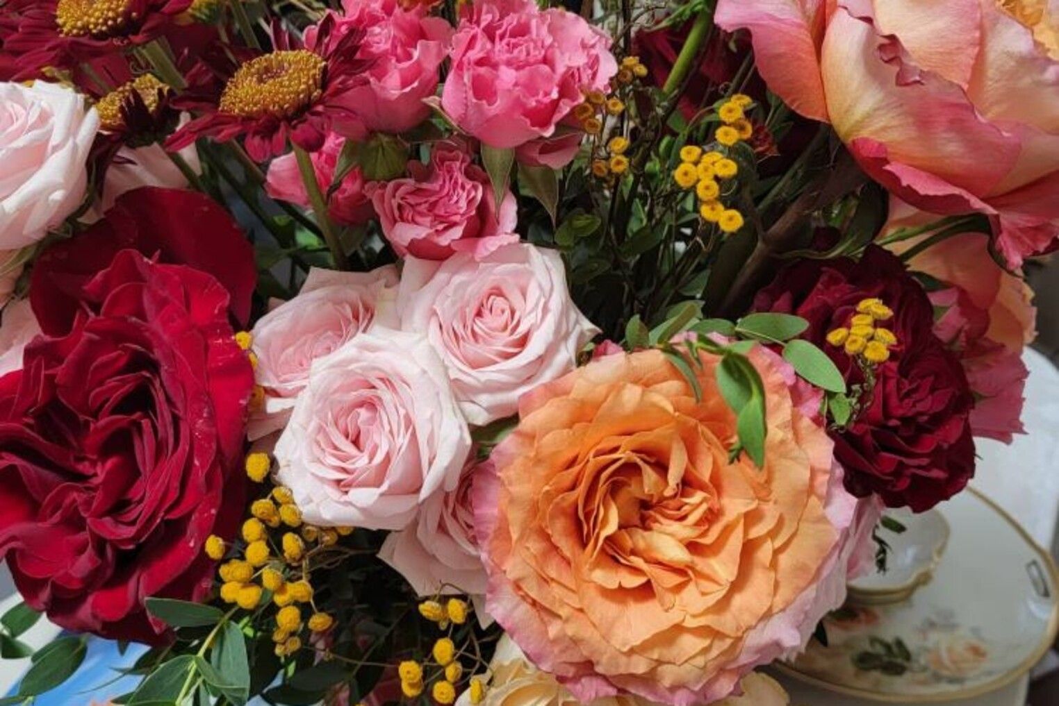 A close up of a bouquet of flowers on a table.