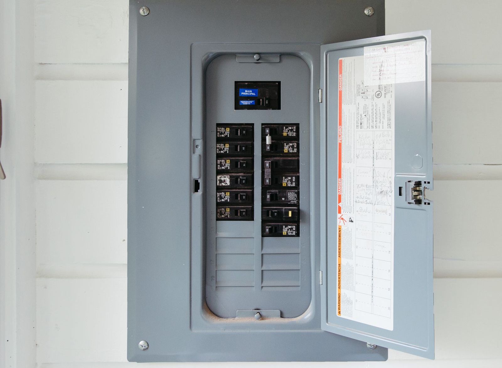 Electrical panel with circuit breakers and wires neatly organized.