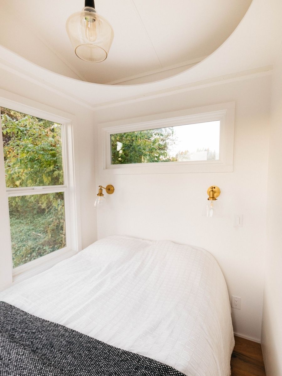 A bedroom with a bed and a window.