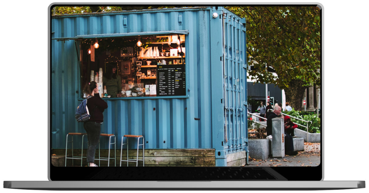 A laptop with a picture of a blue shipping container on the screen.