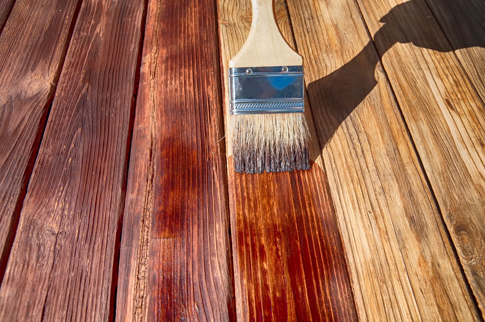 A brush is sitting on top of a wooden table.